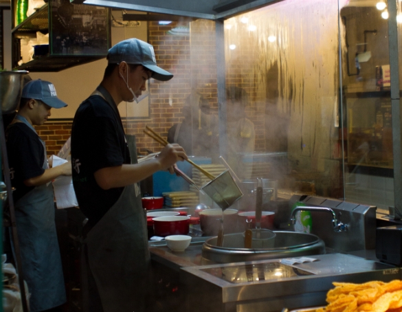 man making noodles from a distant