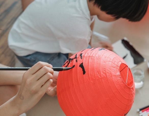 close up of someone writing on chinese lantern