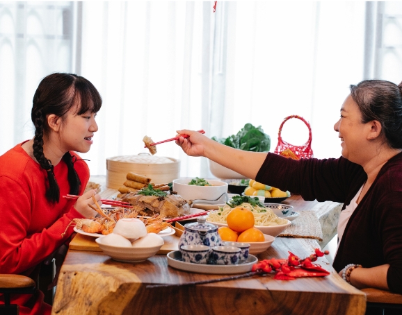 mother and daughter sharing food