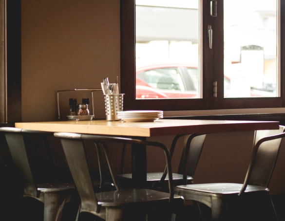 wooden table and empty metal chairs